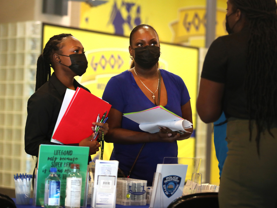 Kyonna Thomas, left, and Mary Thomas of Fort Lauderdale, Florida, inquire about a position with the city of Sunrise during a Mega South Florida Job Fair of 2021 at the BB&T Center in Sunrise on Thursday Oct. 29, 2021.