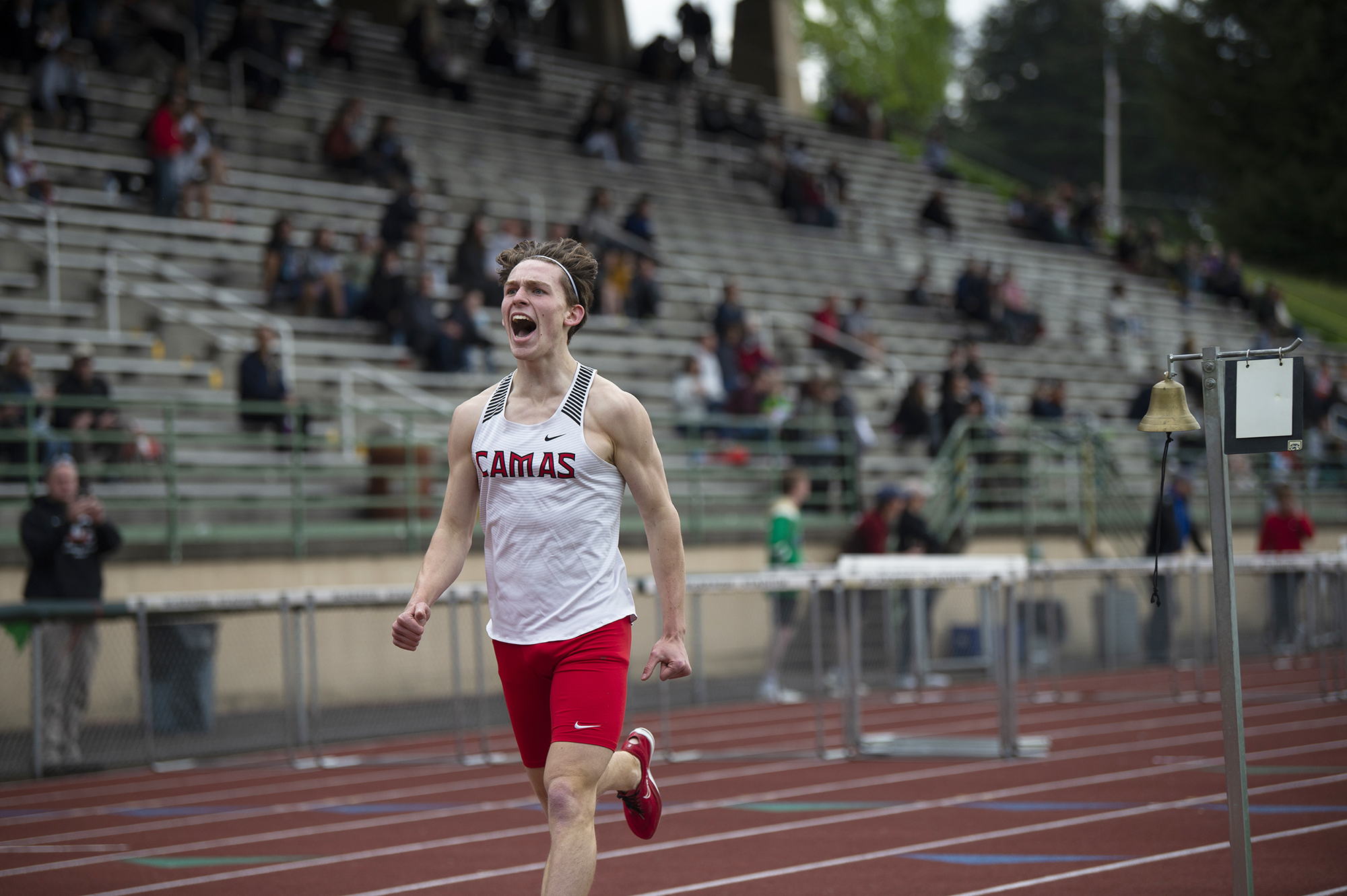 Camas' James Puffer shouts as he crosses the finish line to win the 4A boys 1,600 meters at the 4A and 3A district track and field meet at McKenzie Stadium on Wednesday, May 11, 2022.