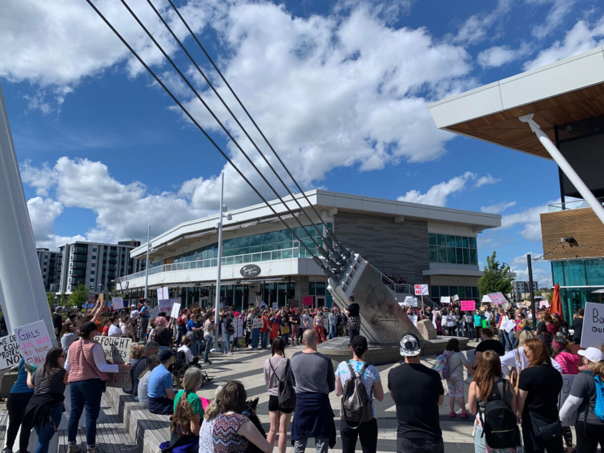 Marchers gather at the Grant Street Pier along the downtown Vancouver waterfront on Saturday in support of abortion rights.