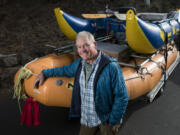 Peter Fox stands next to a pair of rafts in the driveway of his Bend, Ore., home.