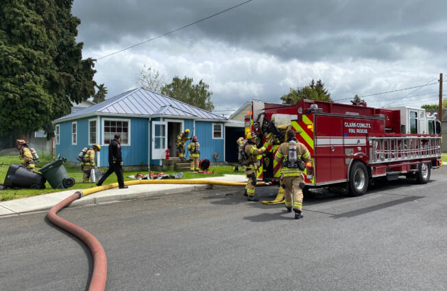 Clark-Cowlitz Fire Rescue firefighters enter a burning house in Woodland on Wednesday afternoon to search for three pets inside.