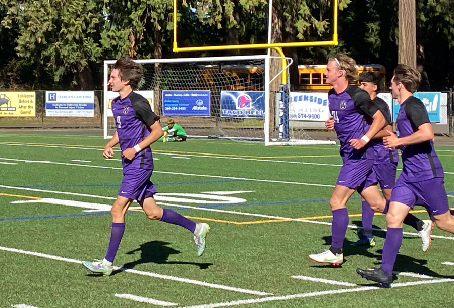 Columbia River?s Alex Harris, left, after scoring his third goal of the match against Othello in the 2A state quarterfinal Saturday, May 22, 2022, at Kiggins Bowl.