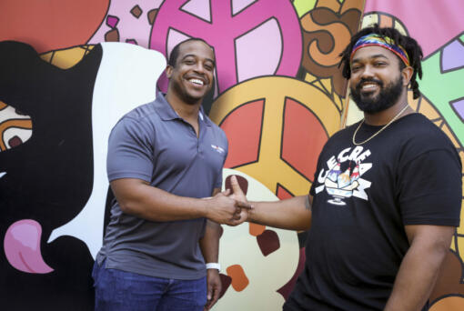 Franchise partners Eric Taylor, left, and Antonio McBroom, right, outside the Midtown Tampa, Florida, Ben & Jerry's when it was under construction in 2021. The childhood pals are part of a partnership that owns 10 stores in six states.