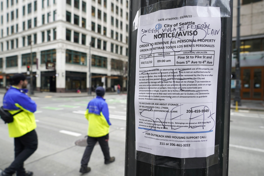 An official notice of the clearing of an encampment of tents used by people experiencing homelessness is posted Friday, March 11, 2022, in Westlake Park in downtown Seattle. Increasingly in liberal cities across the country ??? where people living in tents in public spaces have long been tolerated ??? leaders are removing encampments and pushing other strict measures to address homelessness that would have been unheard of a few years ago. (AP Photo/Ted S.