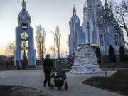 A man pushes a stroller past a church and some sandbags in Vinnytsia, Ukraine, on March 16. Egor Cotov, 34, lives Vinnytsia and works for Vancouver-based ToolBelt. He says Vinnytsia is a safe area.