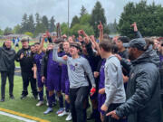 Columbia River players and coaches celebrate with the Class 2A state boys soccer third-place trophy on Saturday, May 28, 2022, in Tumwater.