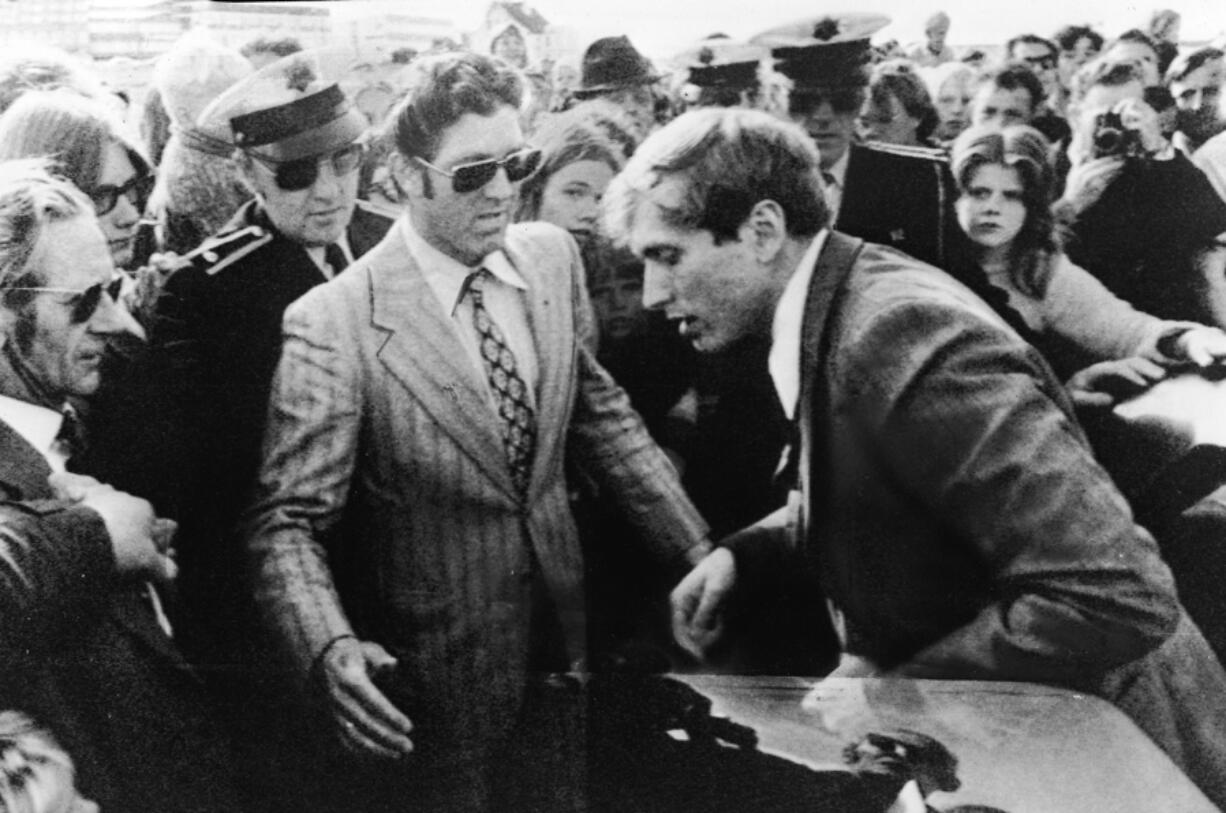 American chess champion and prodigy, the controversial and temperamental Bobby Fischer, exits a car into a waiting crowd which includes several uniformed Icelandic policemen as he arrives for his third match with Soviet world champion Boris Spassky at the Reykjavik Exhibition Hall, Reykjavik, Iceland, July 17, 1972.