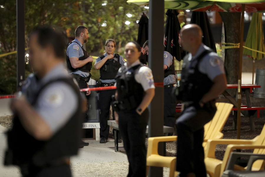 Chicago police work an area along the Riverwalk on May 20, 2022, near where a man was taken into custody after being shot by an off-duty Cook County Sheriff officer who was working security at Millennium Park, police said.