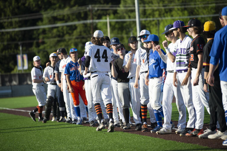 Zach Hauser of Battle Ground (44) greets his teammates as the members of the National League all-stars are introduced during the Clark County High School Senior All-Star baseball series at the Ridgefield Outdoor Recreation Center on Tuesday, May 31, 2022.