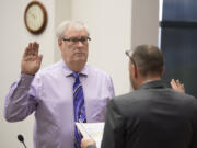 New Clark County Councilor Richard Rylander, left, is sworn in by Clark County Clerk Scott Weber at the Clark County Public Service Center on Tuesday morning.