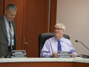 Clark County Councilors Gary Medvigy, left, and Richard Rylander chat as they take a seat before Rylander's first council meeting May 3.