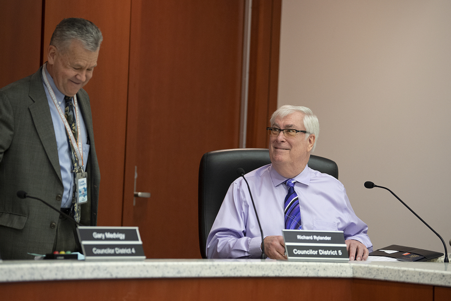 Clark County Councilors Gary Medvigy, left, and Richard Rylander chat as they take a seat before Rylander's first council meeting May 3.