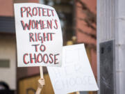 Local abortion rights supporters wave signs Tuesday evening.