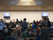 Students gather in the cafeteria at View Ridge Middle School before school on May 4. Among the plans to alleviate overcrowding in Ridgefield schools would be the conversions of two extracurricular spaces at View Ridge -- the wrestling room and the Black Box Theatre -- into multiple new classroom spaces.
