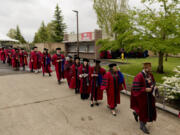 Washington State University Vancouver master's degree graduates march toward the amphitheater as Saturday's 2022 commencement ceremony gets underway at the Clark County Event Center at the Fairgrounds.