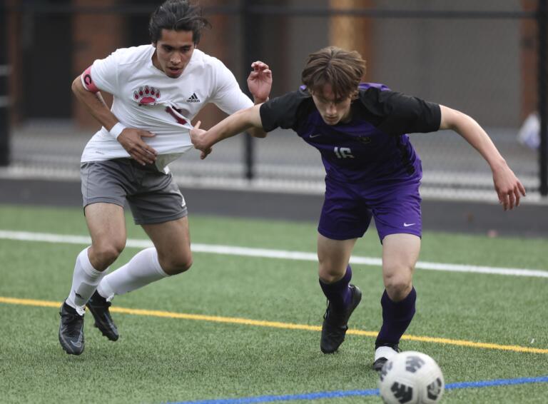 Columbia River's Elliot McClafferty, right, battles for the ball against Isaac Madrigal, left, in the first round of the Class 2A state playoffs.