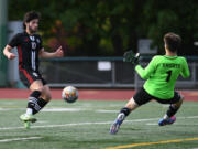 Union senior Isaiah Bunda, left, shoots the ball Wednesday, May 18, 2022, during the Titans??? 1-0 loss to Kamiak in the first round of the 4A state playoffs at McKenzie Stadium.