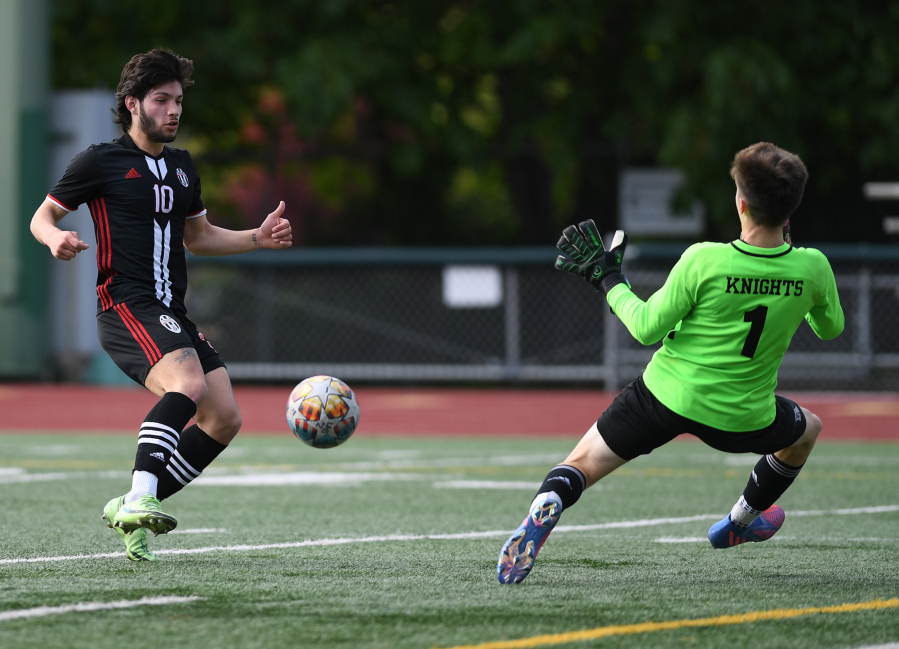 Union senior Isaiah Bunda, left, shoots the ball Wednesday, May 18, 2022, during the Titans??? 1-0 loss to Kamiak in the first round of the 4A state playoffs at McKenzie Stadium.