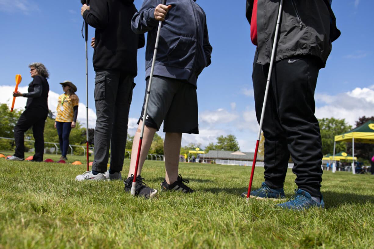 Athletes wait their turn to compete in the turbo javelin during a track meet at the Washington State School for the Blind on Thursday morning.