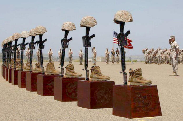 Battlefield crosses — created with a soldier’s rifle, helmet, dog tags and boots — honor the 25 Dark Horses who died during their deployment in Afghanistan.