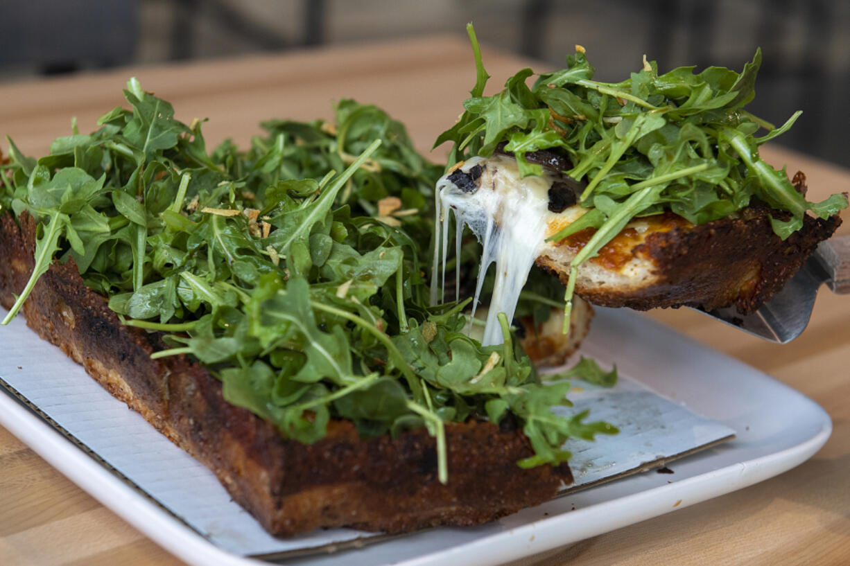 Ruse Brewing Crust Collective's Towering Trees pizza is topped with mushrooms, garlic confit, French fried onion, mozzarella, arugula and truffle salt.