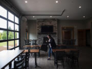 Columbia Ridge Winery co-owner Angela Sanchez prepares her new tasting room for the upcoming Memorial Day weekend. The winery has 1 acre of pinot noir grapes on-site to make wine with. They use varietals from other places to make other wines.