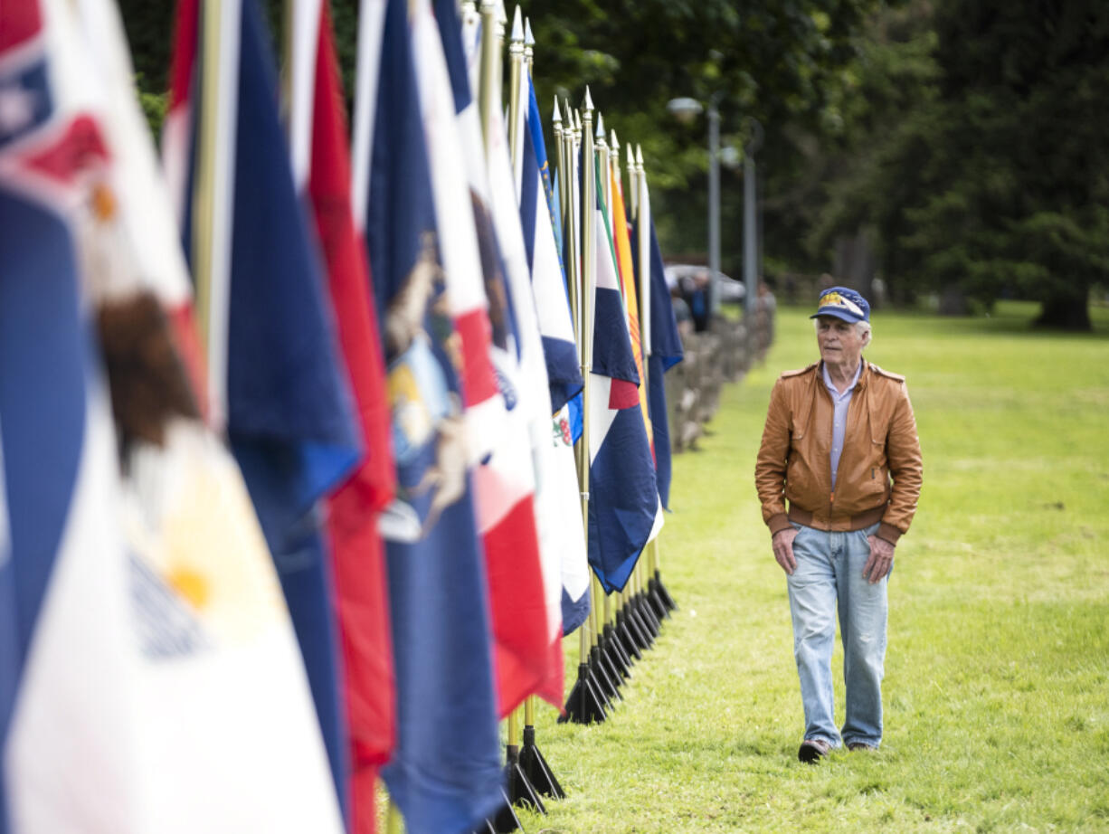 Peter Rideout of Portland looks at state flags Monday, May 30, 2022, during the Memorial Day Observance event at Fort Vancouver National Historic Site.
