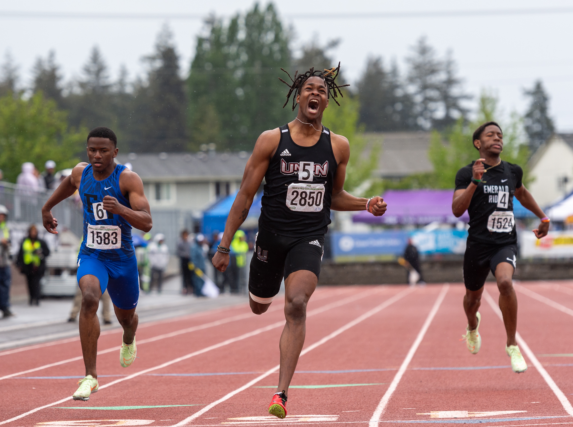 Union's Tobias Merriweather roars as he crosses the finish line as champion of the 4A Boys 200 with a personal best time of 21.80 seconds at the 4A/3A/2A State Track and Field Championships on Saturday, May 28, 2022, at Mount Tahoma High School in Tacoma.
