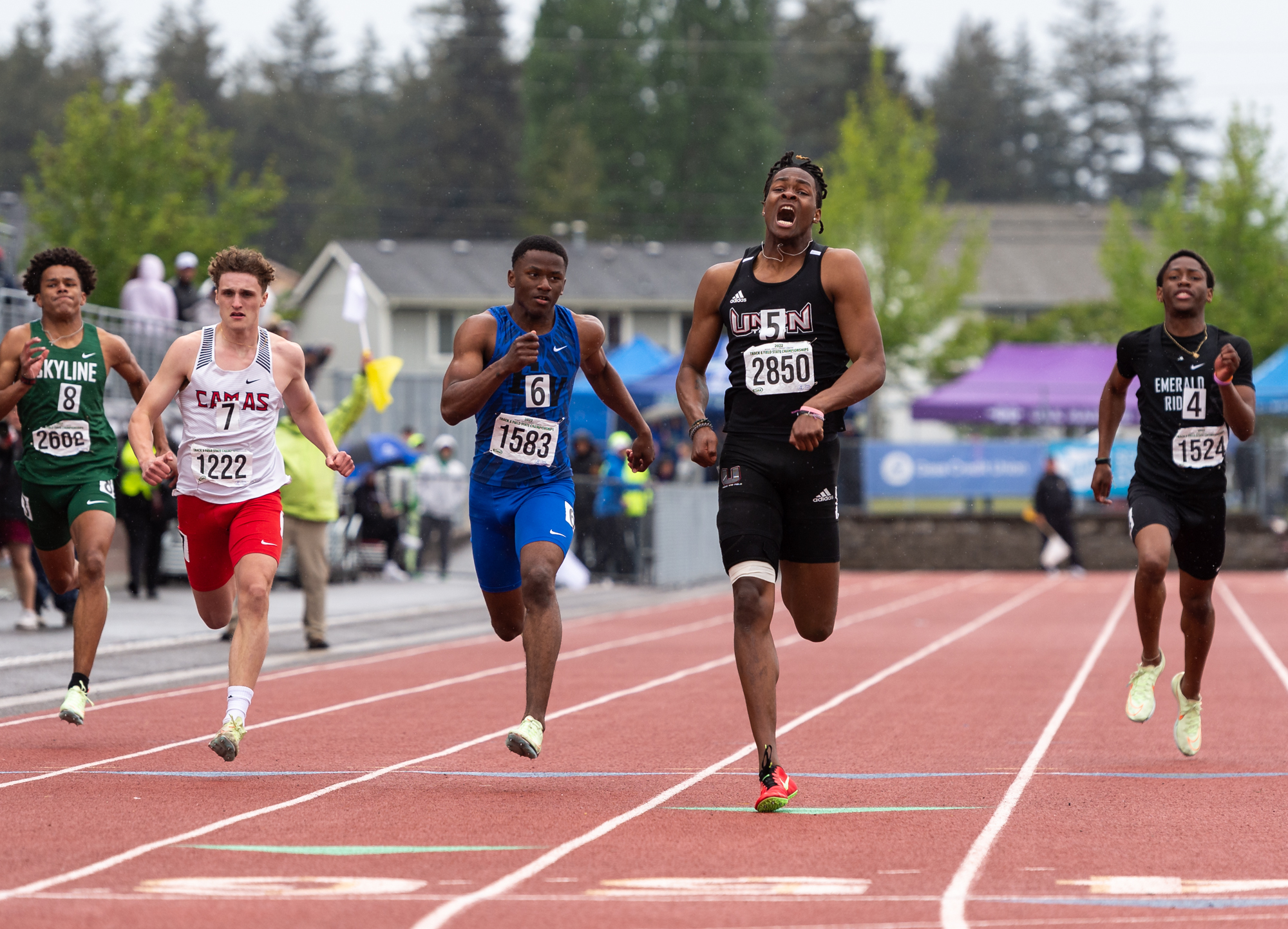 Union's Tobias Merriweather starts screamng with steps to the finish line as he wins the 4A Boys 100 at the 4A/3A/2A State Track and Field Championships on Saturday, May 28, 2022, at Mount Tahoma High School in Tacoma.