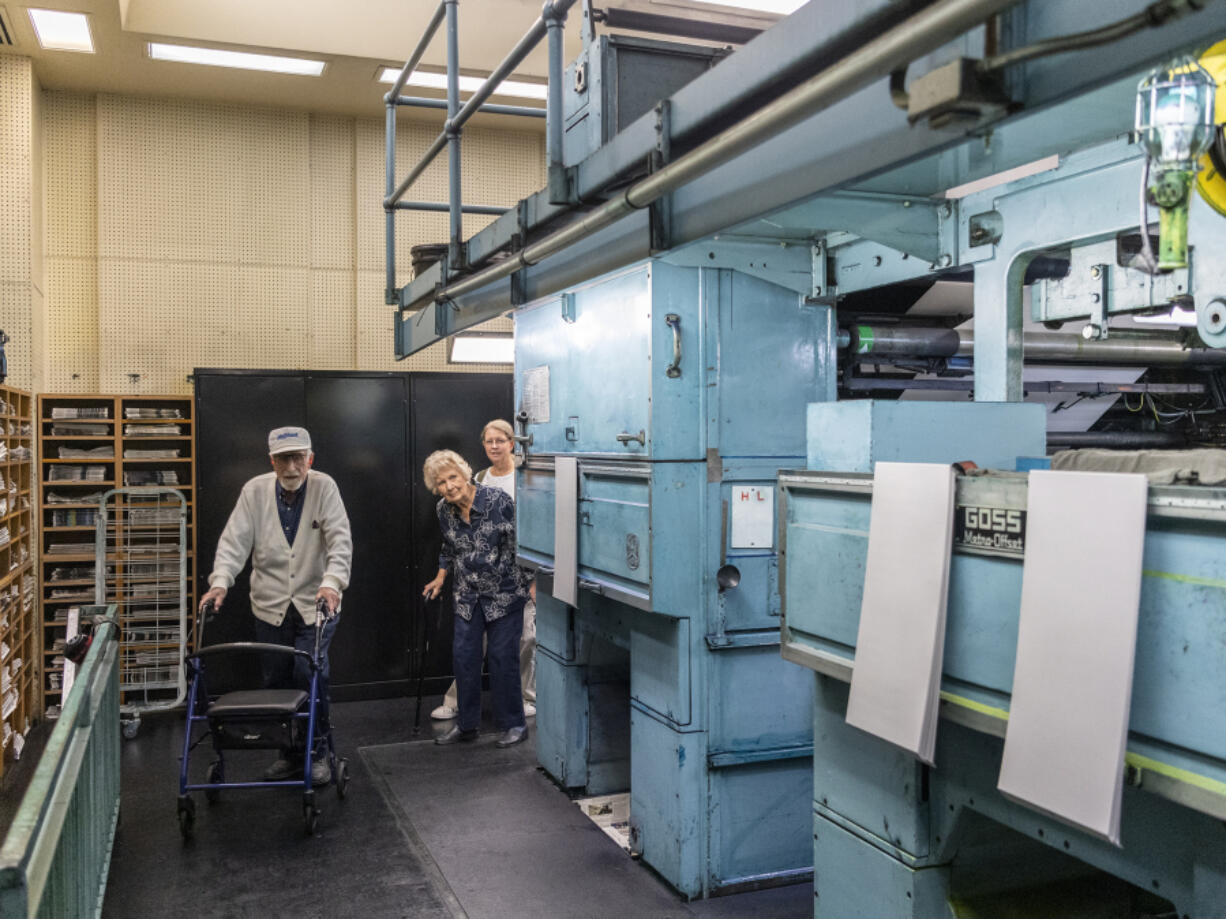 Frank Wallace, left, along with his wife Donna Wallace, center, and Deb Wallace, his daughter-in-law, tour the The Columbian's pressroom on Tuesday.