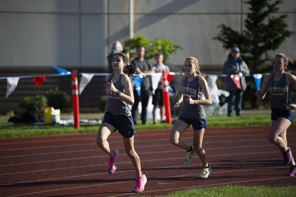 Seton Catholic's Alexis Leone (left) leads teammmates Avery Garrison and Lara Carrion as the Cougars post a 1-2-3 sweep of the girls 1,600 meters at the Class 1A District 4 track and field meet at Seton Catholic on Thursday, May 19, 2022.