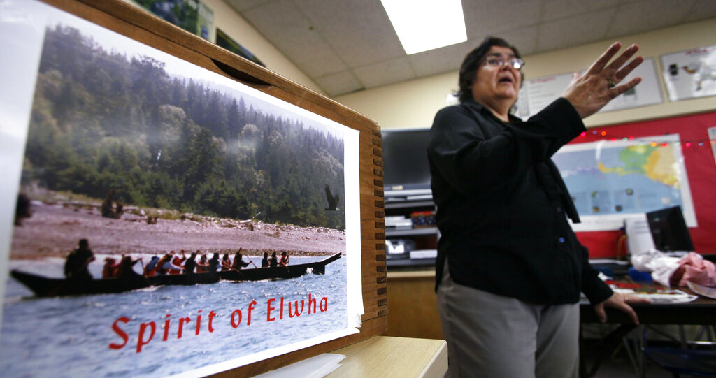 In this photo taken Oct. 6, 2010, teacher Jamie Valadez talks in her Port Angeles High School classroom about paddling on a native canoe journey, in Port Angeles, Wash. Valadez, a member of the Klallam tribe that has lived along the nearby Elwah River for centuries, brings tribal history alive in her classroom. She says the same experience can be had in any school in America, using the ready-made Native American curricula just waiting on the Web for interested teachers.