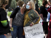 Aileen Luppert, left, gets a hug from her Aunt Eve Luppert during the Planned Parenthood abortion-rights rally in front of the Federal Courthouse in Spokane, Wash., on Tuesday, May 3, 2022.