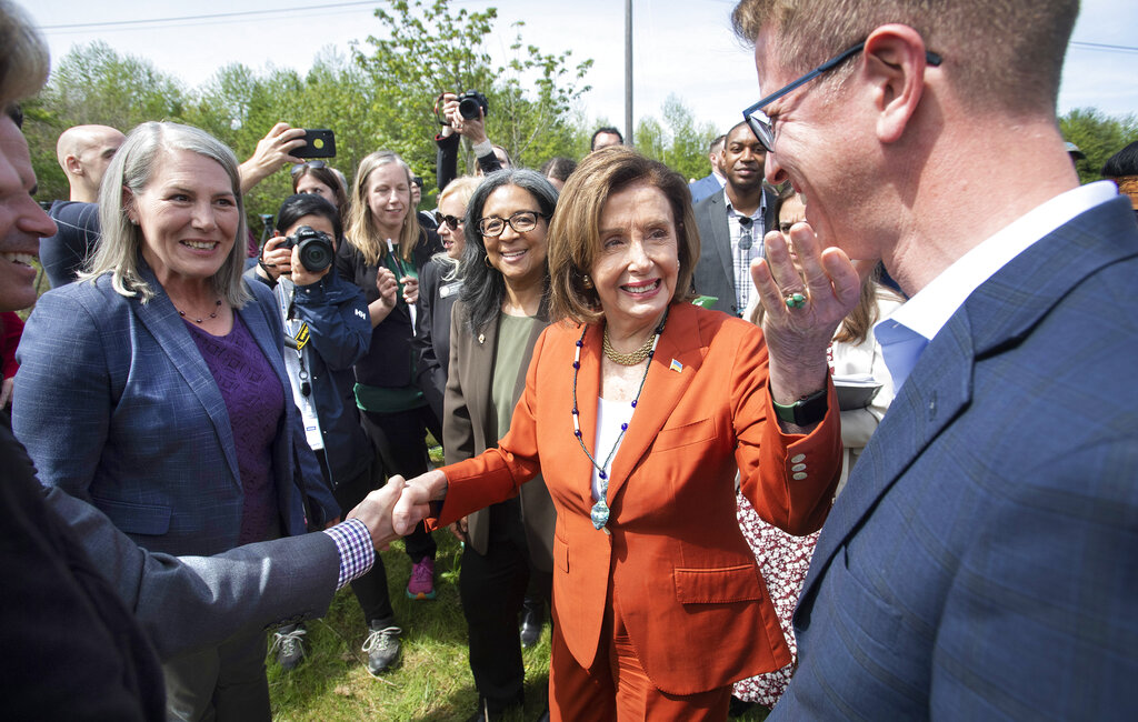 Speaker of the U.S. House of Representatives Nancy Pelosi touches the chin of U.S. Rep. Derek Kilmer as she thanks him following an Infrastructure Investment and Jobs Act press conference in front of the Chambers Creek Dam in University Place, Wash. on Wednesday, May 4, 2022.