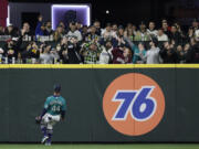 Seattle Mariners center fielder Julio Rodriguez watches as Tampa Bay Rays' Manuel Margot's three-run home run ball lands in the stands in the ninth inning of a baseball game, Friday, May 6, 2022, in Seattle. The Rays won 8-7.