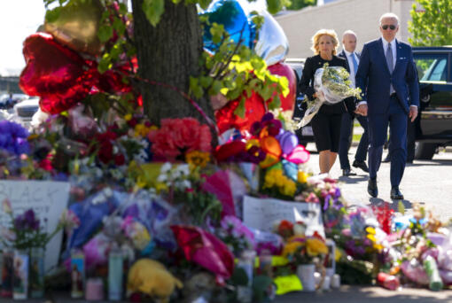 President Joe Biden and first lady Jill Biden pay their respects to the victims of Saturday's shooting at a memorial across the street from the TOPS Market in Buffalo, N.Y., Tuesday, May 17, 2022.