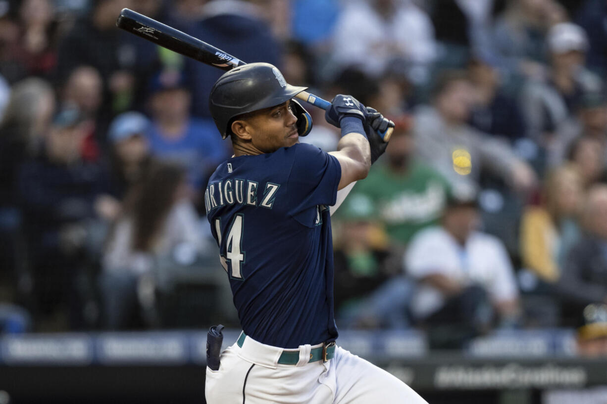 Seattle Mariners' Julio Rodriguez hits a single off Oakland Athletics starting pitcher Zach Logue during the fifth inning of a baseball game, Monday, May 23, 2022, in Seattle.