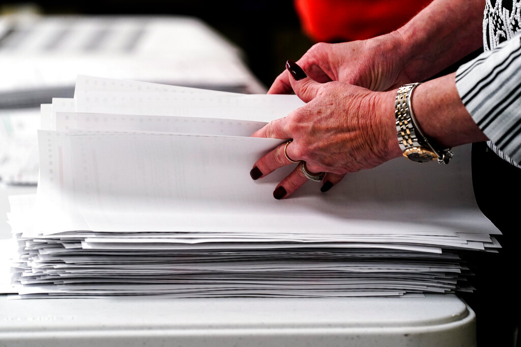 Election workers perform a recount of ballots from the recent primary election at the Montour County administration center in Danville, Pa., Friday, May 27, 2022.