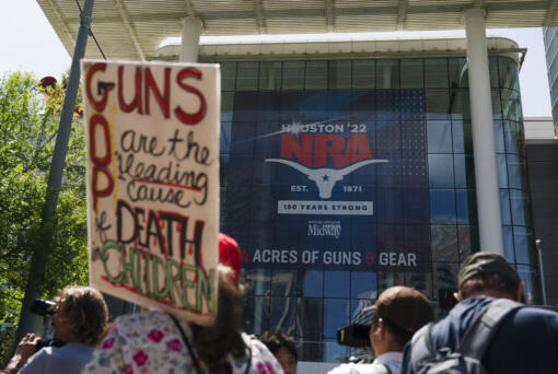 People gather outside the George R. Brown Convention Center to protest the National Rifle Association's annual meeting in Houston, Friday, May 27, 2022. (AP Photo/Jae C.