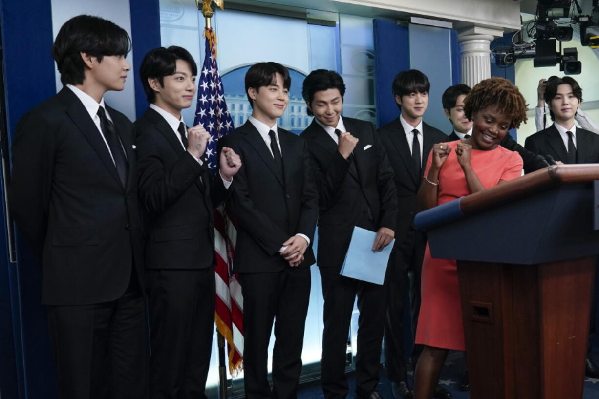 Members of the K-pop supergroup BTS, from left, V, Jungkook, Jimin, RM, Jin, J-Hope, Suga, join White House press secretary Karine Jean-Pierre during the daily briefing at the White House in Washington, Tuesday, May 31, 2022.