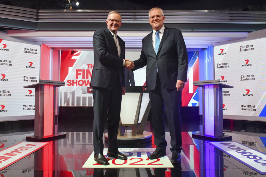Australian Prime Minister Scott Morrison, right and Australian Opposition Leader Anthony Albanese shake hands ahead of the leaders' debate in Sydney, Australia, Wednesday, May 11, 2022. A Chinese ambassador says China's engagement with South Pacific island countries poses no threat to Australia, responding to fears that Beijing will establish a military foothold in the Solomon Islands.