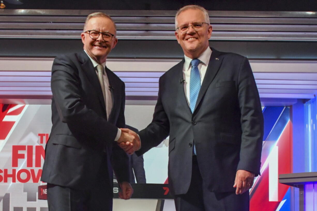 Australian Prime Minister Scott Morrison, right, and Australian opposition leader Anthony Albanese shake hands ahead of the leaders' debate in Sydney, Australia, on May 11, 2022.