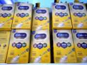 FILE - Infant formula is stacked on a table during a baby formula drive to help with the shortage May 14, 2022, in Houston.  President Joe Biden has invoked the Defense Production Act to speed production of infant formula and has authorized flights to import supply from overseas. (AP Photo/David J.