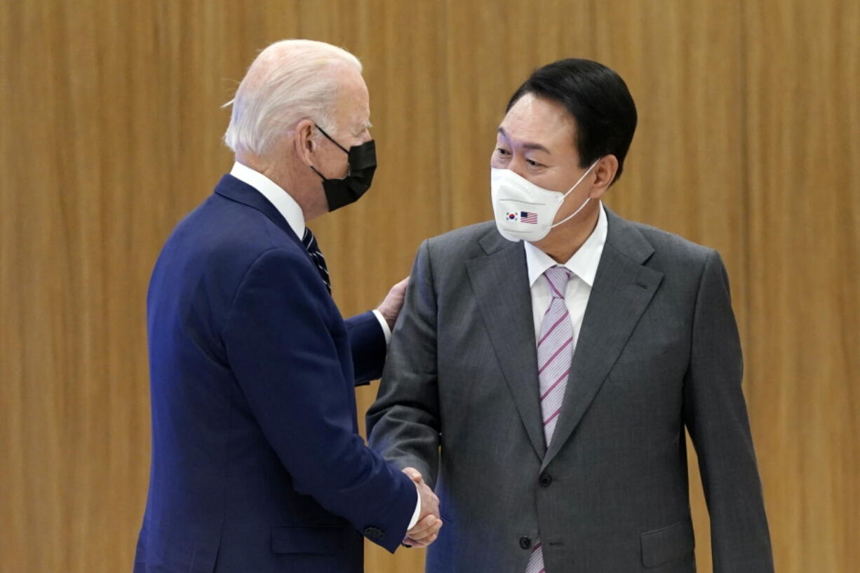 President Joe Biden and South Korean President Yoon Suk Yeol shake hands as they visit the Samsung Electronics Pyeongtaek campus, Friday, May 20, 2022, in Pyeongtaek, South Korea.