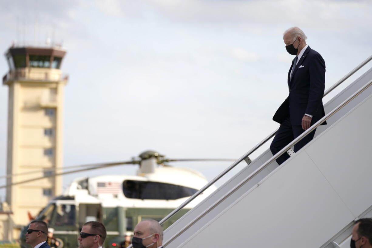 U.S. President Joe Biden, right, disembarks from Air Force One on his arrival at Yokota Air Base, Sunday, May 22, 2022, in Fussa, on the outskirt of Tokyo, Japan.