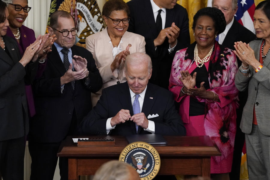 President Joe Biden signs an executive order in the East Room of the White House, Wednesday, May 25, 2022, in Washington. The order comes on the second anniversary of George Floyd's death, and is focused on policing.
