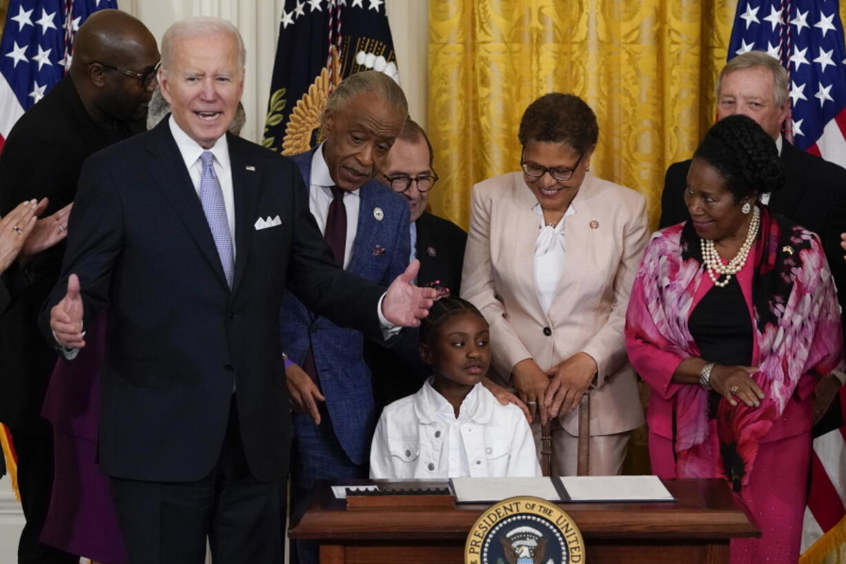 President Joe Biden speaks as Gianna Floyd, the daughter of George Floyd, sits in the chair after Biden signed an executive order in the East Room of the White House, Wednesday, May 25, 2022, in Washington. The order comes on the second anniversary of George Floyd's death, and is focused on policing.