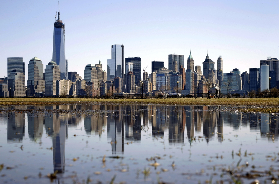 FILE - New York's Lower Manhattan skyline, including the One World Trade Center, left, is reflected in water on April 6, 2013, as seen from Liberty State Park in Jersey City, N.J. Eight of the 10 largest cities in the U.S. lost population during the first year of the pandemic, with only Phoenix and San Antonio gaining new residents from 2020 to 2021, according to new estimates released, Thursday, May 26, 2022, by the U.S. Census Bureau.