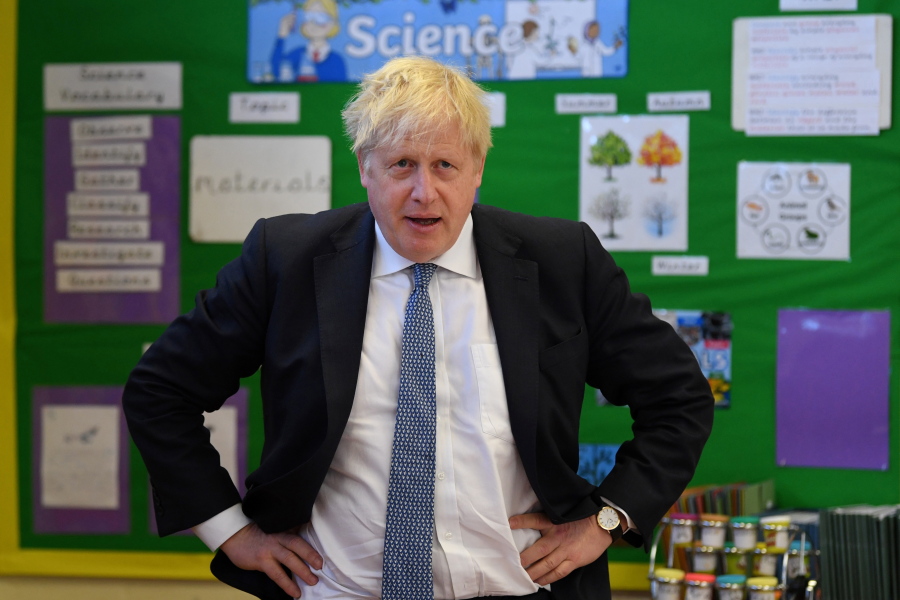 Britain's Prime Minister Boris Johnson visits the Field End Infant school, in South Ruislip, London, Friday May 6, 2022, following the local government elections. Britain's governing Conservatives have suffered local election losses in their few London strongholds. Voting held Thursday for thousands of seats on more than 200 local councils decided who will oversee garbage collection and the filling of potholes, but were also seen as an important barometer of public opinion ahead of the next national election.