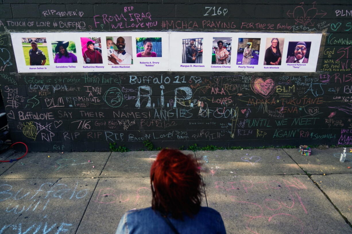 A person visits a makeshift memorial near the scene of Saturday's shooting at a supermarket, in Buffalo, Thursday, May 19, 2022.